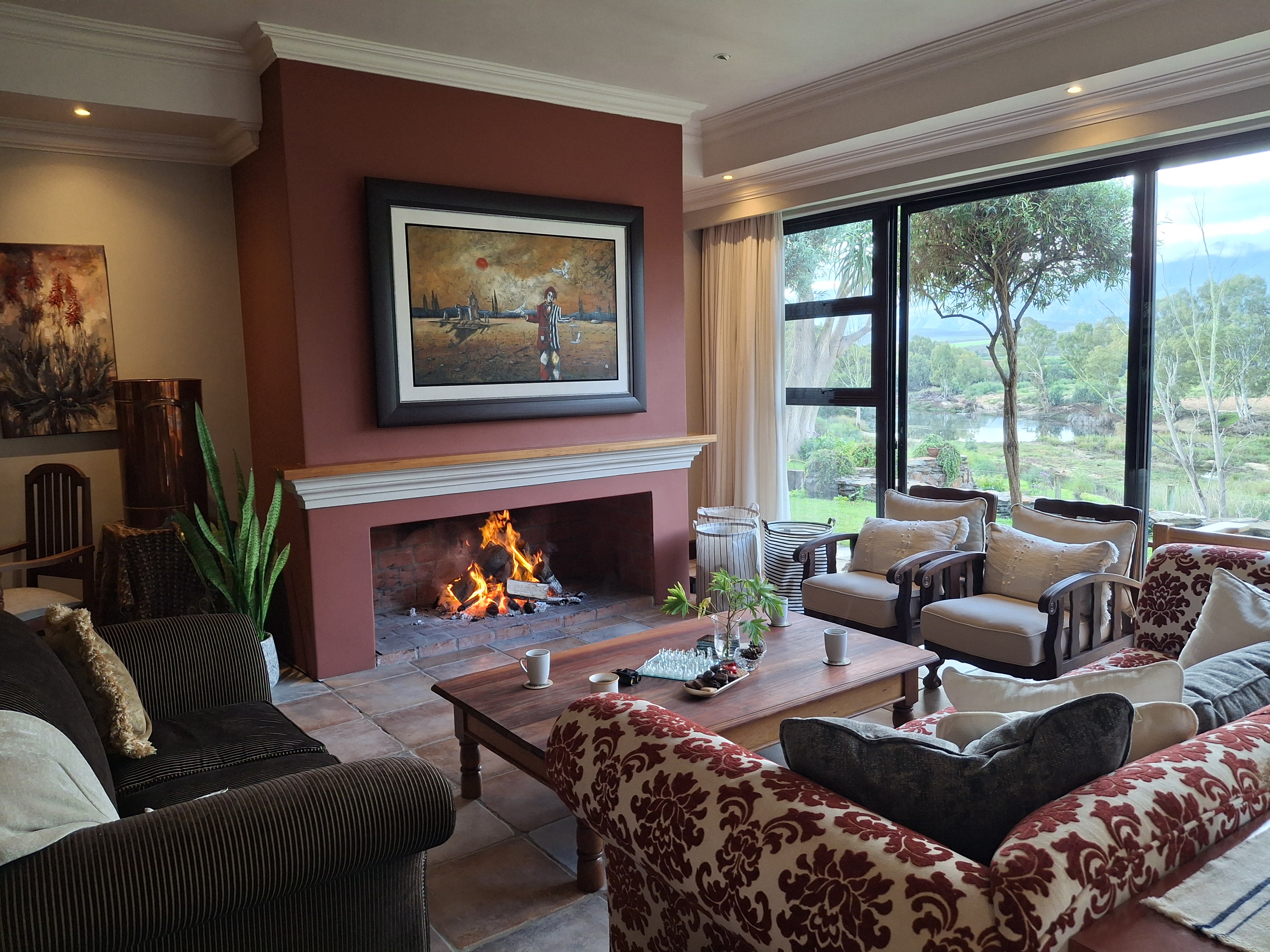 Riverhide self-catering riverside villa lounge with indoor fireplace and Breede River views